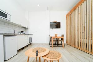 a kitchen with a table and two chairs in a room at Sunny Day Deluxe 10 in Arguineguín