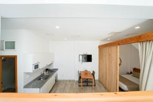 a room with a kitchen and a bedroom with a bed at Sunny Day Deluxe 10 in Arguineguín +10 photos