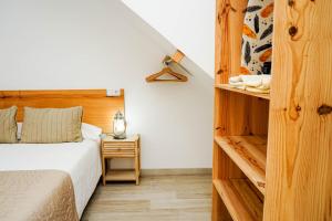 a bedroom with a bed and a wooden wall at Sunny Day Deluxe 10 in Arguineguín