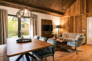 a dining room and living room with a table and chairs at Stylish Loft Apartment with Mountain View near the Lake in Afritz