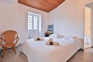 a bedroom with a bed with two bags on it at Longe 17 - élégante propriété avec deux maisons in Longeville-sur-Mer