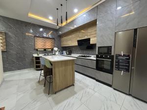 a large kitchen with a island in the middle at Tombell Homes in Ibadan
