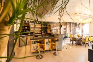 a restaurant with a bar with yellow chairs and tables at Magnifique domaine avec piscine in Montréal