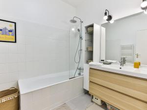 a white bathroom with a sink and a shower at Maison des Surfeurs in Les Sables-d'Olonne