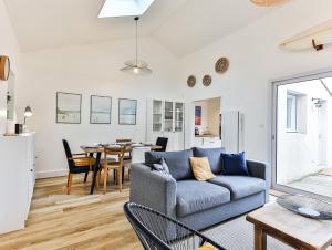 a living room with a couch and a table at Maison des Surfeurs in Les Sables-d'Olonne