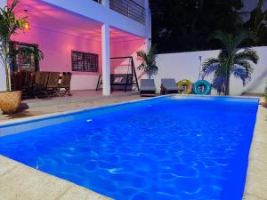 a large blue swimming pool in front of a house at Villa Keur Lune - Saly - SENEGAL in Saly Portudal