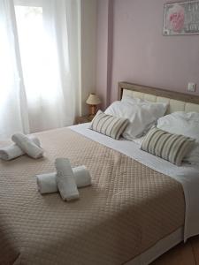 a large white bed with two pillows on it at Dimitris House Petriti in Petrití