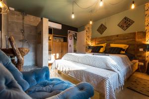 a bedroom with a large bed and a blue chair at Magnifique domaine avec piscine in Montréal +69 photos
