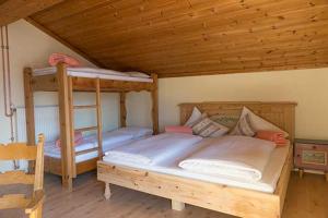 a bedroom with two bunk beds in a cabin at Galtalm in Fulpmes
