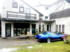 a blue car parked in front of a house at Vilnius Luxury Apartment 1 in Vilnius