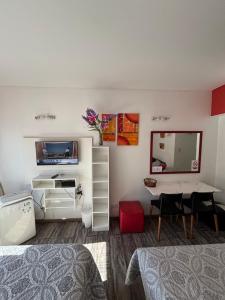 a room with a bed and a desk and a table at Departamento en Microcentro (Obelisco) in Buenos Aires
