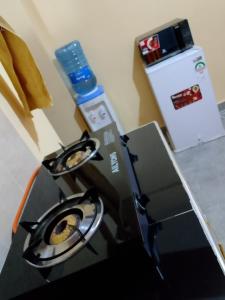 a kitchen with a stove in a room at Mwembe Airbnbs in Kisii +21 photos