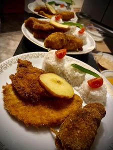 three plates of food on a table with rice at Guest Zimmer Nora in Zamárdi