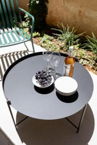 a table with a plate of food and wine glasses at The J Luxury Apartments Near Mahane Yehuda - Perfect for Shabbat Stays in Jerusalem
