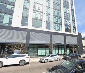 a group of cars parked in front of a building at Five Points South Spacious 2BR with 2 Queens D5 in Birmingham