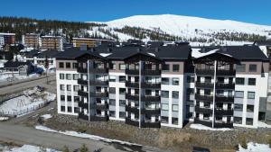 an aerial view of a large apartment building with snow at Ylläs Chalets IX 9502 in Kolari
