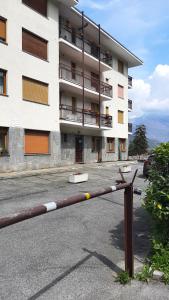 a fence in front of a large building at Casa Pioda in Chiomonte