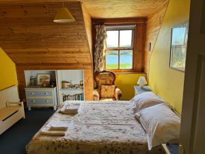 a bedroom with a large bed in a wooden house at Kermor B&B in Claddaghduff
