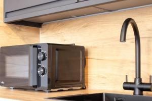 a microwave oven sitting on top of a kitchen counter at Modern 2-Bed Apartment, Greenock in Greenock +33 photos