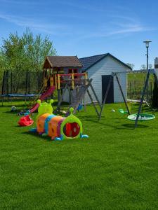 a park with a playground with a play equipment at Domek Ga-Ba in Sarbinowo