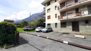 two cars parked in a parking lot next to a building at Casa Pioda in Chiomonte