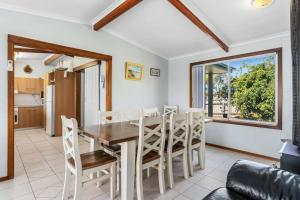 a dining room with a table and chairs at Spikes Place - Waterfront Serenity for Groups in Hindmarsh Island