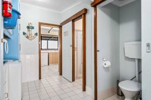 a bathroom with a toilet and a sink at Spikes Place - Waterfront Serenity for Groups in Hindmarsh Island +11 photos