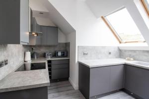 a kitchen with a sink and a window at Spacious 3-Bed Apartment, Alva, Clackmannanshire in Alva