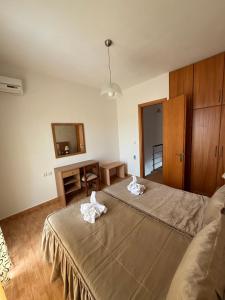 a bedroom with a bed and a table and a mirror at Anestis House in Anaxos