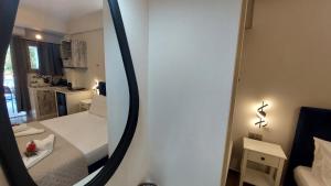 a mirror in a small room with a bed at NESTOR LUXURY Studios in Vathi +64 photos