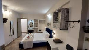 a room with a bed and a desk in it at NESTOR LUXURY Studios in Vathi