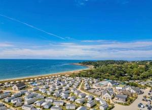 an aerial view of a beach with houses and the ocean at Mobilhome camping St jacques in Sarzeau