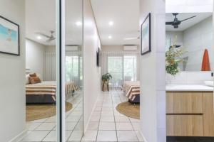 a room with a bathroom and a bedroom at Huge Stylish Townhouse in Stuart Park +24 photos