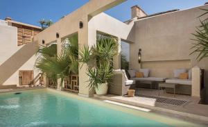 a villa with a swimming pool and a house at Riad Rossi in Marrakesh