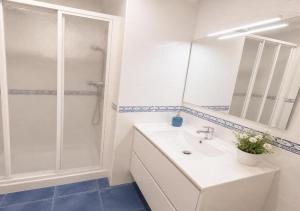 a white bathroom with a shower and a sink at Apartamento vistas al mar in Viveiro +18 photos