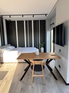a bedroom with a table and a bed and a tv at Bavaro apartments 4 in Ivano-Frankivsk