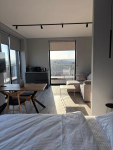 a bedroom with a bed and a table and a living room at Bavaro apartments 4 in Ivano-Frankivsk