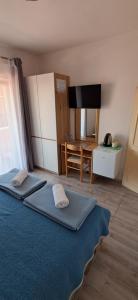 a bedroom with a bed with two towels on it at Pansion Maria in Zadar