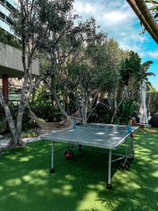 a ping pong table on the grass in a yard at Grand Hotel Del Mare Resort & Spa in Bordighera