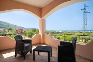 a balcony with chairs and a table and a view at Dimora dei Cedri in Santa Maria del Cedro