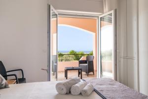 a bedroom with a bed and a view of a balcony at Dimora dei Cedri in Santa Maria del Cedro