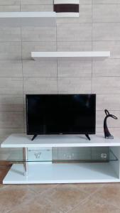 a flat screen tv on a white entertainment center at Apartments Ema Vir in Vir