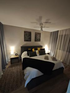 a bedroom with a large bed with yellow and black pillows at Sitges Casablanca in Sant Pere de Ribes +21 photos