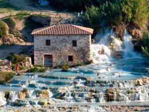 a building in the middle of a waterfall at Verde Luna B in Orbetello