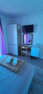 a bedroom with a bed with blue lights on it at Pansion Maria in Zadar +22 photos