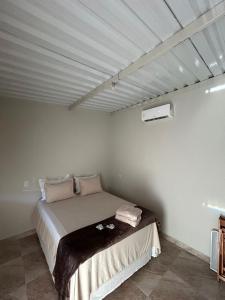 a bedroom with a bed in a room at Cerrado da Canastra Chalé Quartinho simples in São Roque de Minas