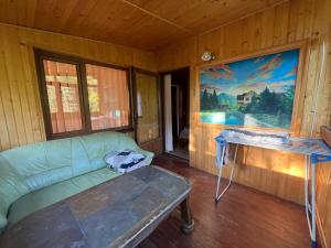 a living room with a couch and a table at Садиба "У Пані Галини" з форельним господарством in Kosiv