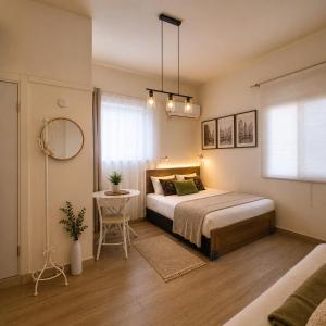 a bedroom with a bed and a table and a window at bugrashov 13 room in Tel Aviv