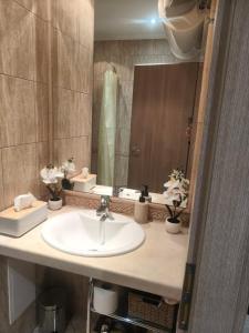 a bathroom with a sink and a mirror at Joy Escape Varna in Varna City +17 photos