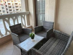a balcony with a table and chairs on a balcony at Joy Escape Varna in Varna City